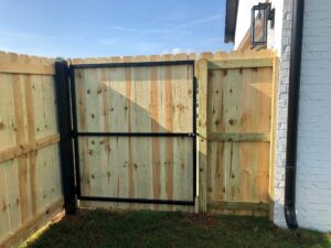 Privacy gate with steel frame on wood fence of residential property in Conway, Arkansas