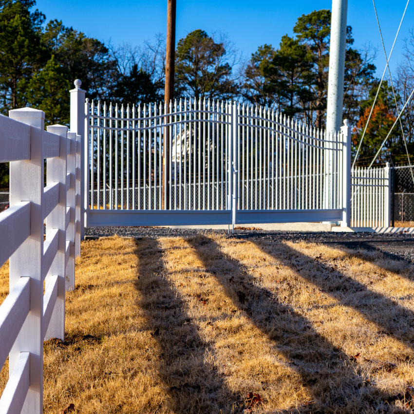 Custom white steel gate operator in front of residential drive