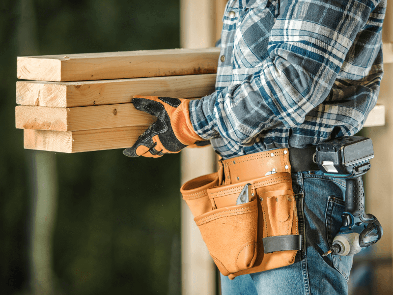 Bradford Fencing - Image of Fence Contractor Holding Planks of Wood